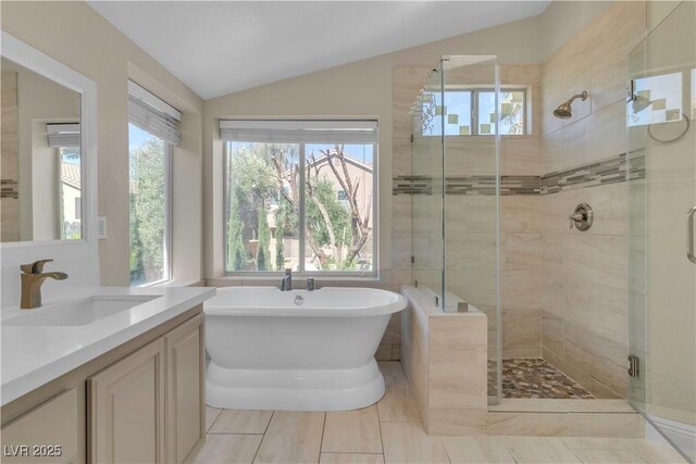 1717 Double Arch Ct, Las Vegas, NV 89128 - bathroom with a stall shower, tile patterned flooring, vanity, a freestanding tub, and vaulted ceiling