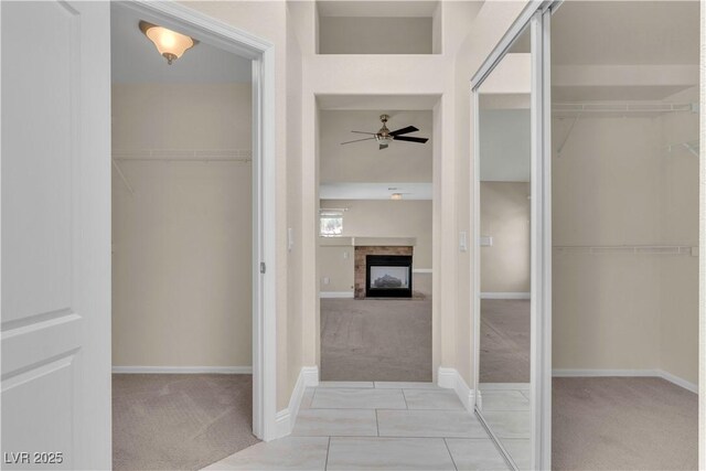 1717 Double Arch Ct, Las Vegas, NV 89128 - bathroom with ceiling fan, a fireplace, baseboards, and a walk in closet