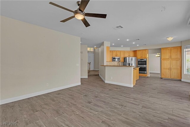1717 Double Arch Ct, Las Vegas, NV 89128 - unfurnished living room featuring light wood-type flooring, visible vents, baseboards, and a ceiling fan
