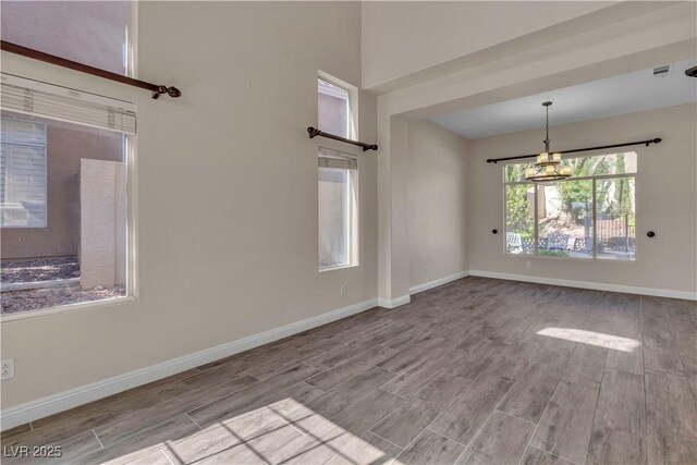 1717 Double Arch Ct, Las Vegas, NV 89128 - interior space featuring visible vents, wood finished floors, baseboards, and a notable chandelier