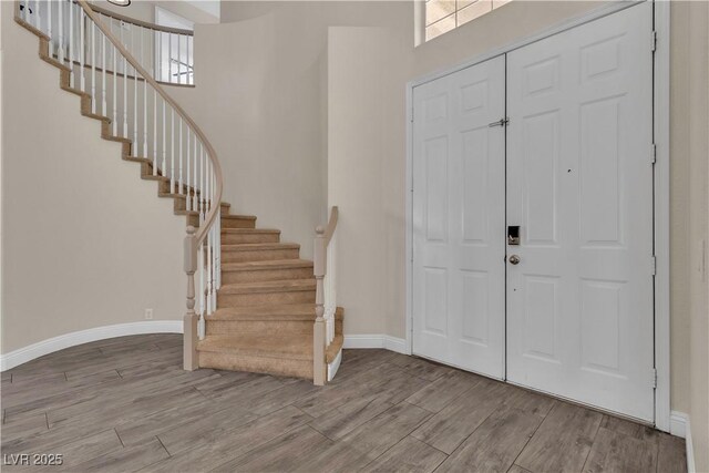 1717 Double Arch Ct, Las Vegas, NV 89128 - foyer entrance featuring wood finished floors, baseboards, stairway, and healthy amount of natural light