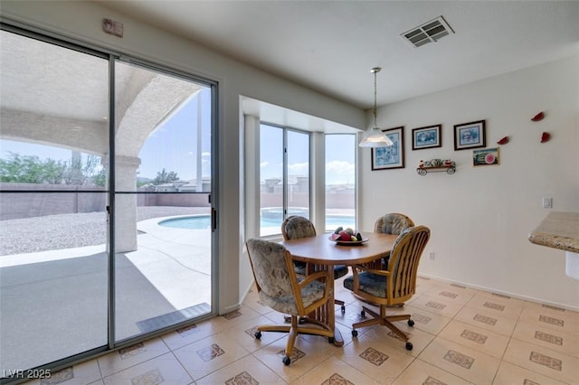 dining room with light tile patterned floors and baseboards