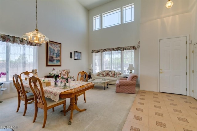 dining space with a high ceiling and a chandelier