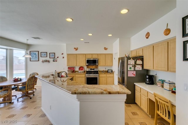 kitchen with appliances with stainless steel finishes, light brown cabinets, light tile patterned floors, recessed lighting, and light stone countertops