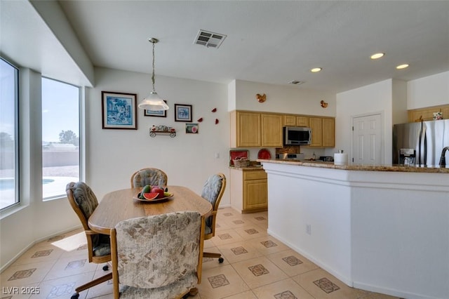 dining area featuring healthy amount of natural light, recessed lighting, light tile patterned floors, and baseboards