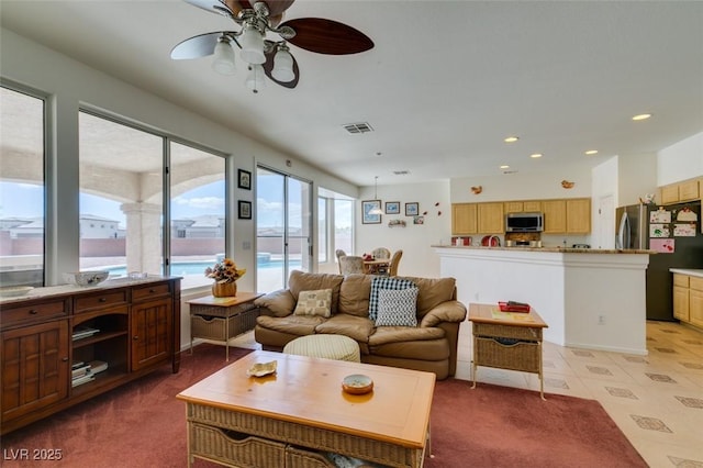living area featuring ceiling fan and recessed lighting