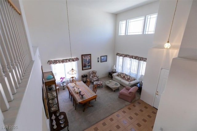 living area featuring a high ceiling