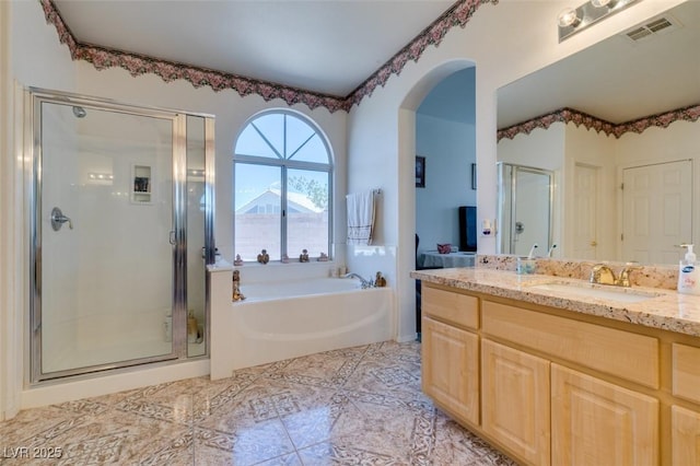 bathroom with a garden tub, a shower stall, vanity, and tile patterned flooring