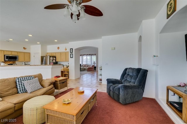 living room with arched walkways, ceiling fan, and recessed lighting