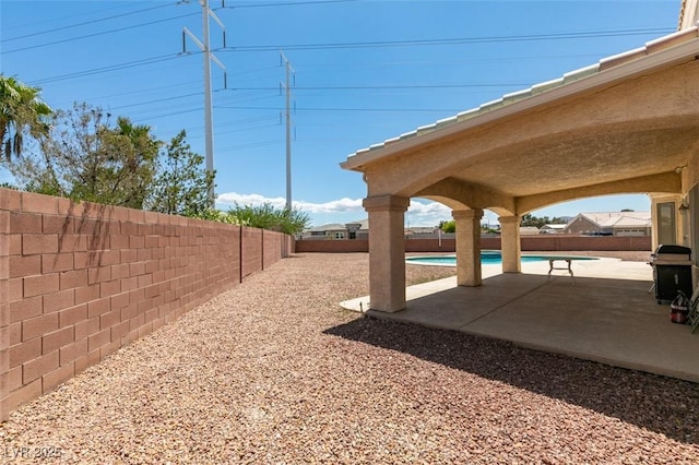 fenced backyard with a patio