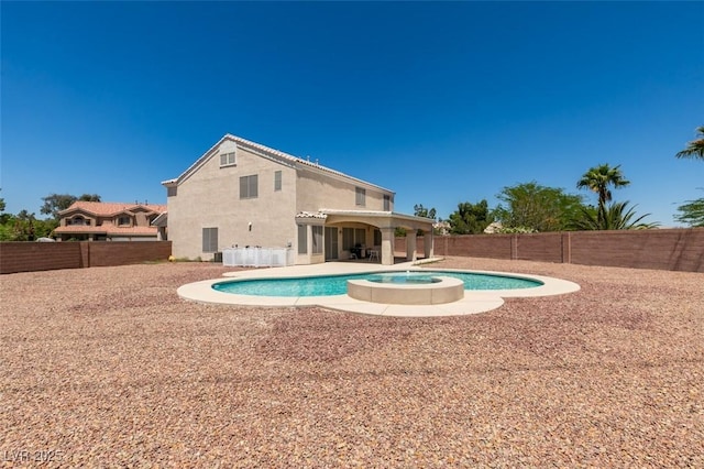 view of swimming pool with a pool with connected hot tub, a fenced backyard, and a patio