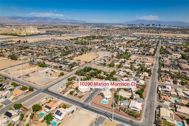 aerial view of property and surrounding area featuring a mountainous background