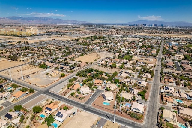 aerial view of property's location with a mountain backdrop and nearby suburban area
