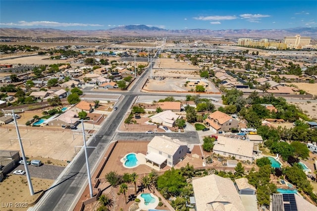 aerial perspective of suburban area with a pool area and mountains
