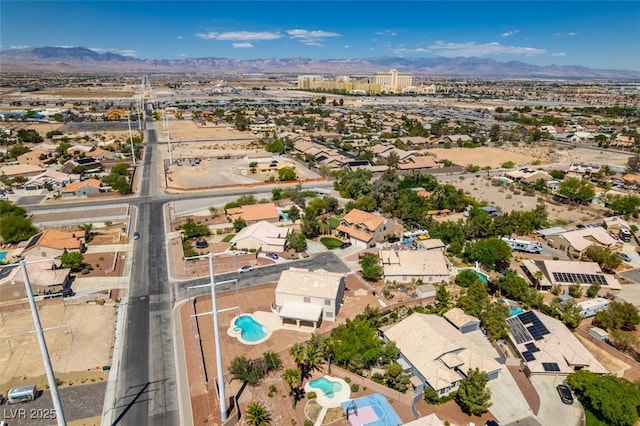 aerial view of residential area with mountains and a pool area