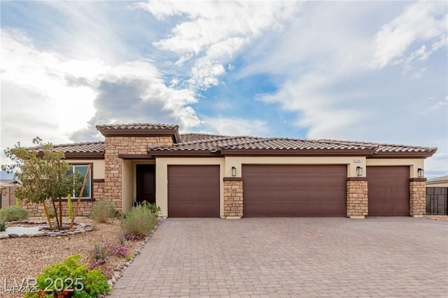 5741 N Park St, Las Vegas, NV 89149 - view of front of property featuring stone siding, stucco siding, a garage, and driveway