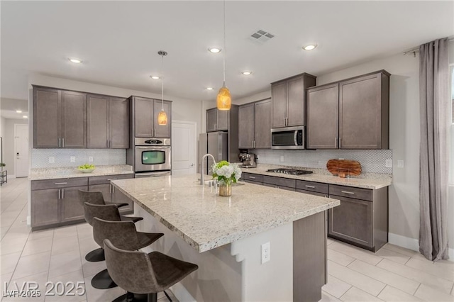 5741 N Park St, Las Vegas, NV 89149 - kitchen with stainless steel appliances, decorative backsplash, and light tile patterned floors