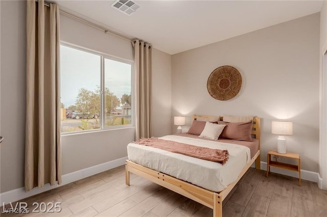 5741 N Park St, Las Vegas, NV 89149 - bedroom with baseboards, visible vents, and light wood-style floors