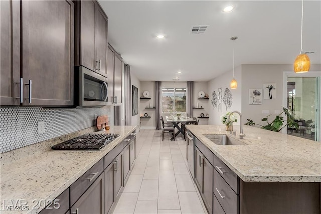 5741 N Park St, Las Vegas, NV 89149 - kitchen with light tile patterned floors, visible vents, a sink, dark brown cabinetry, and appliances with stainless steel finishes