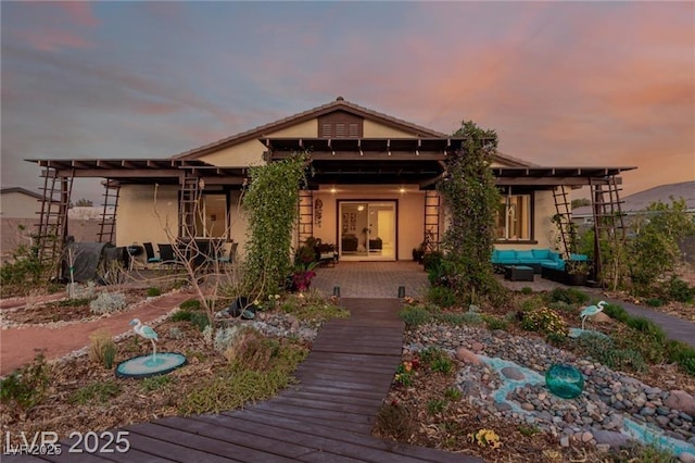 5741 N Park St, Las Vegas, NV 89149 - back of property at dusk featuring a patio area, stucco siding, french doors, and outdoor lounge area