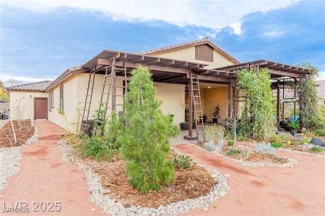 5741 N Park St, Las Vegas, NV 89149 - view of property exterior with stucco siding and a pergola