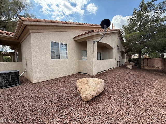 1881 W Alexander Rd Unit 1035, North Las Vegas, NV 89032 - view of side of home featuring cooling unit, a tiled roof, and stucco siding