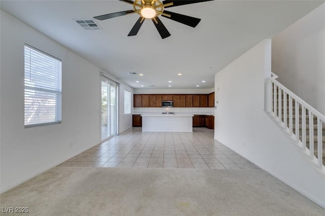 528 Sunny Pointe St, Henderson, NV 89011 - unfurnished living room featuring recessed lighting, light carpet, light tile patterned flooring, a ceiling fan, and stairs