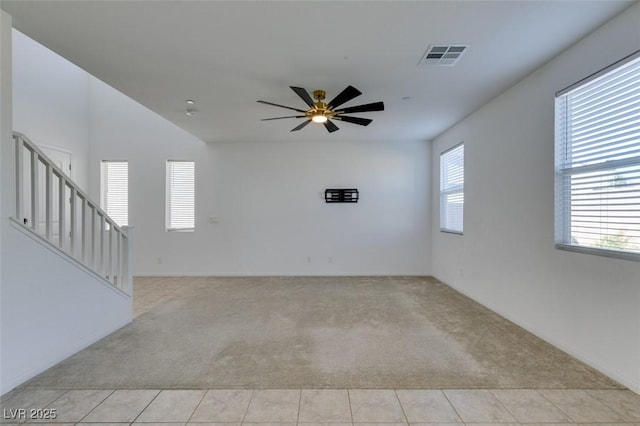528 Sunny Pointe St, Henderson, NV 89011 - unfurnished room with light colored carpet, stairway, a ceiling fan, and baseboards