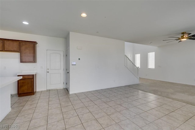 528 Sunny Pointe St, Henderson, NV 89011 - unfurnished living room featuring ceiling fan, stairway, recessed lighting, light carpet, and light tile patterned floors