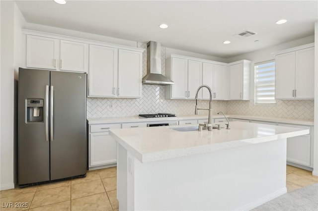 8724 Scalpay St, Las Vegas, NV 89166 - kitchen with stainless steel fridge, wall chimney range hood, a sink, white cabinets, and recessed lighting