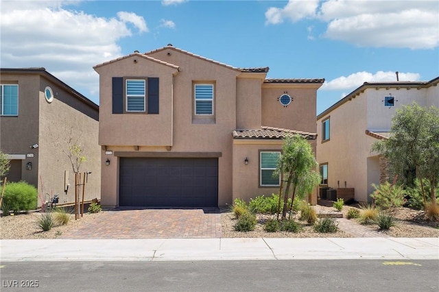 8724 Scalpay St, Las Vegas, NV 89166 - mediterranean / spanish-style home featuring a tile roof, an attached garage, stucco siding, decorative driveway, and cooling unit
