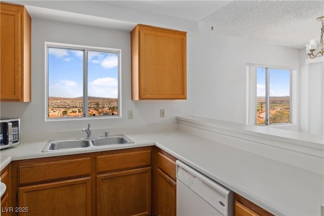 2191 Bay Club Dr Unit 204, Laughlin, NV 89029 - kitchen featuring a sink, stainless steel microwave, plenty of natural light, and white dishwasher