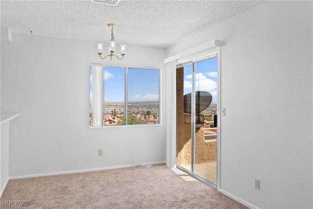 2191 Bay Club Dr Unit 204, Laughlin, NV 89029 - unfurnished dining area featuring baseboards, carpet flooring, an inviting chandelier, and a textured ceiling