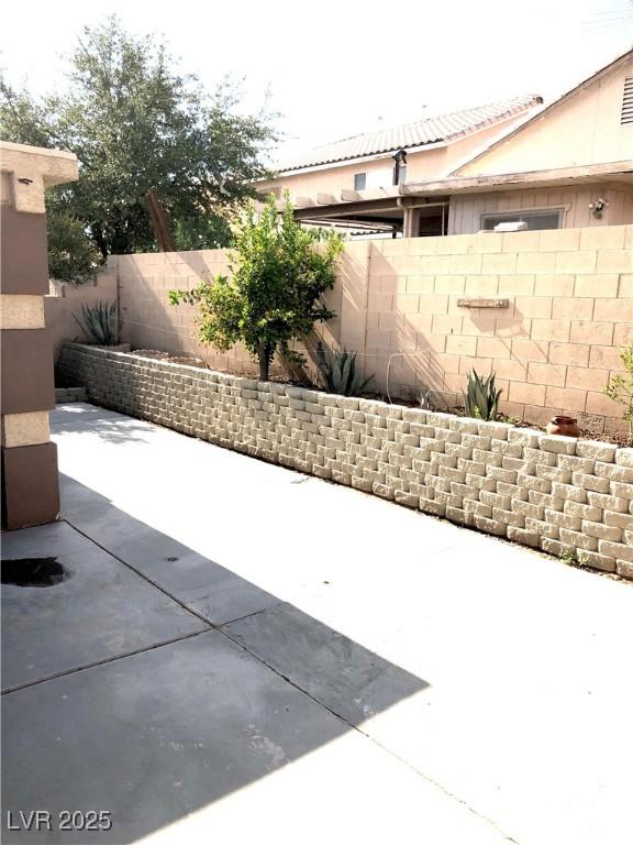 6030 Halehaven Dr, Las Vegas, NV 89110 - fenced backyard featuring a patio