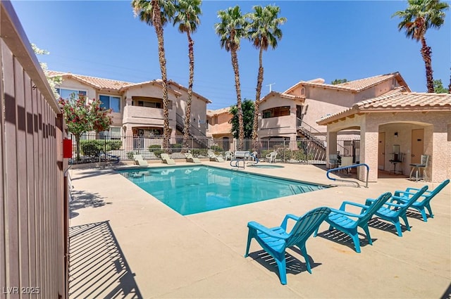 pool featuring a patio area and fence