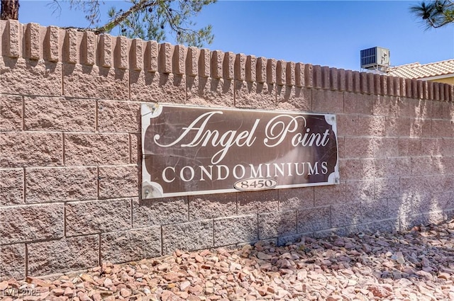 community / neighborhood sign featuring fence