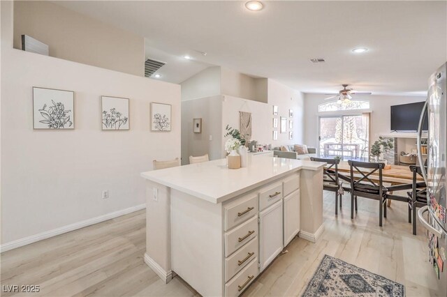 8136 Shady Glen Ave, Las Vegas, NV 89131 - kitchen featuring open floor plan, a ceiling fan, freestanding refrigerator, light wood-style floors, and recessed lighting