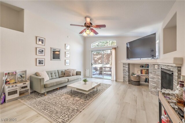 8136 Shady Glen Ave, Las Vegas, NV 89131 - living area with a fireplace, ceiling fan, and wood finished floors