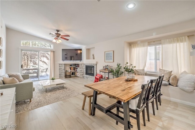 8136 Shady Glen Ave, Las Vegas, NV 89131 - dining space featuring a ceiling fan, healthy amount of natural light, wood finished floors, a fireplace, and vaulted ceiling