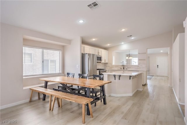 8136 Shady Glen Ave, Las Vegas, NV 89131 - dining room with light wood-style floors, lofted ceiling, and recessed lighting