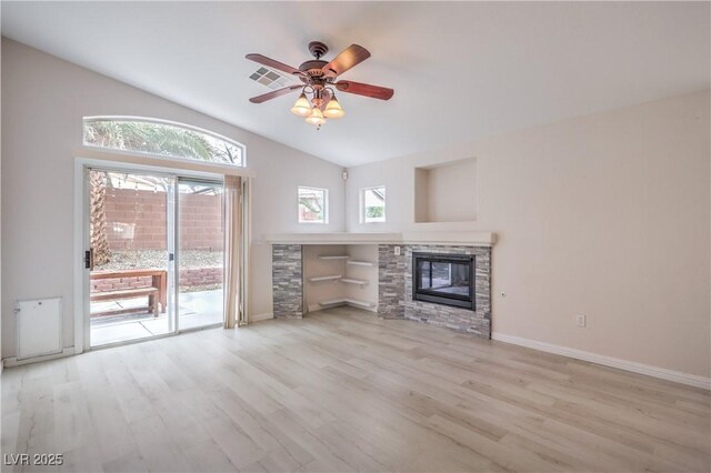 8136 Shady Glen Ave, Las Vegas, NV 89131 - unfurnished living room featuring lofted ceiling, wood finished floors, a ceiling fan, and a stone fireplace