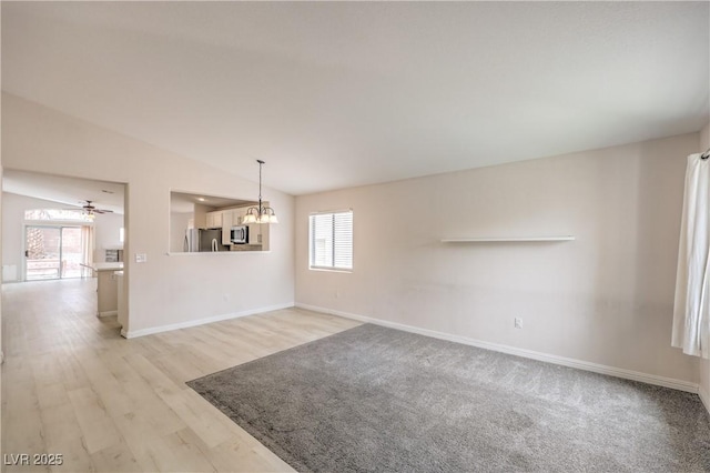 8136 Shady Glen Ave, Las Vegas, NV 89131 - unfurnished living room featuring a chandelier, lofted ceiling, light wood-type flooring, and a ceiling fan