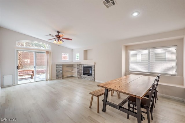8136 Shady Glen Ave, Las Vegas, NV 89131 - dining room featuring light wood-type flooring, ceiling fan, lofted ceiling, a fireplace, and recessed lighting