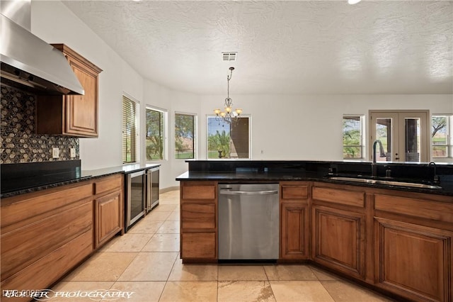 653 Paloma Cir, Mesquite, NV 89027 - kitchen featuring beverage cooler, dishwasher, an inviting chandelier, a sink, and wall chimney exhaust hood