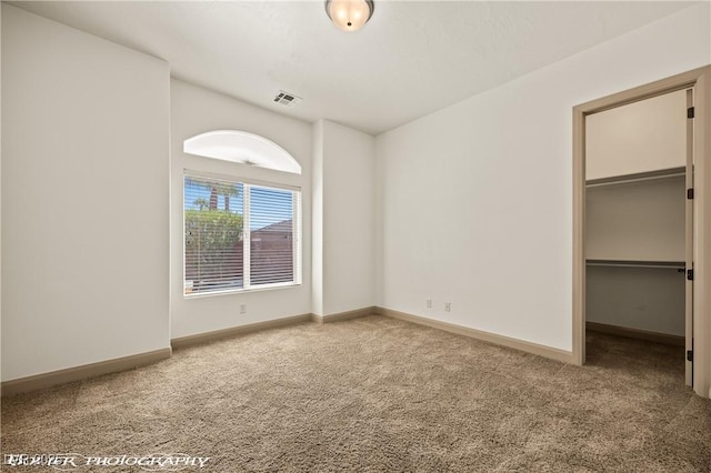 653 Paloma Cir, Mesquite, NV 89027 - unfurnished bedroom featuring baseboards, a spacious closet, carpet flooring, and visible vents