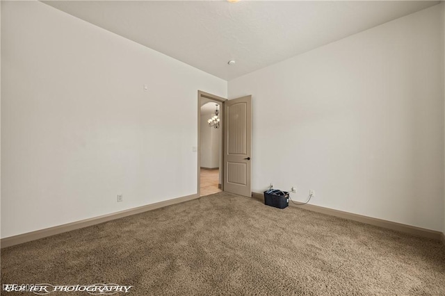 653 Paloma Cir, Mesquite, NV 89027 - empty room featuring carpet, a chandelier, and baseboards