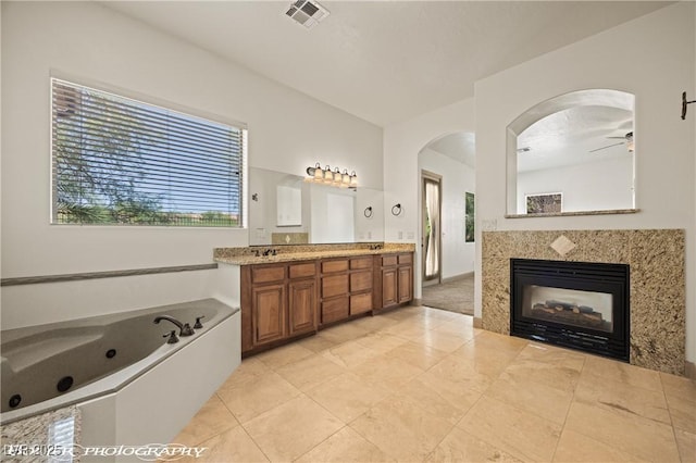 653 Paloma Cir, Mesquite, NV 89027 - bathroom with a tub with jets, visible vents, tile patterned flooring, a ceiling fan, and double vanity