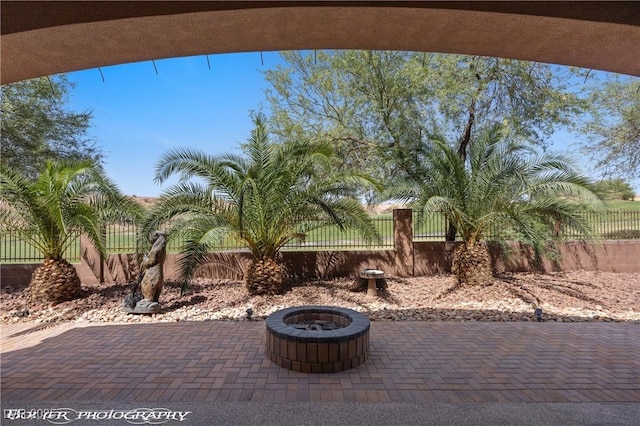 653 Paloma Cir, Mesquite, NV 89027 - view of patio / terrace with a fire pit and a fenced backyard