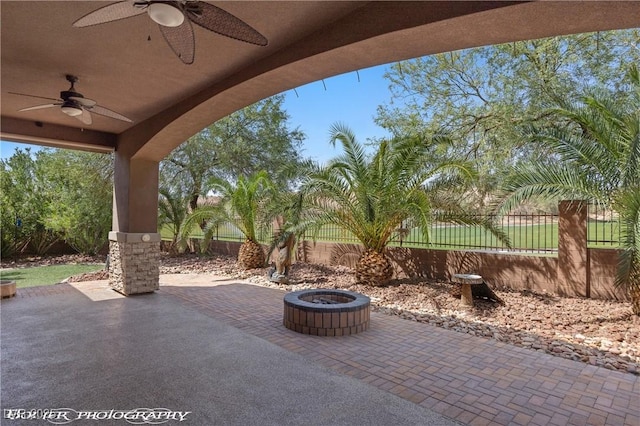653 Paloma Cir, Mesquite, NV 89027 - view of patio featuring a fenced backyard, ceiling fan, and an outdoor fire pit