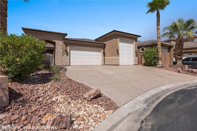 653 Paloma Cir, Mesquite, NV 89027 - prairie-style home with stone siding, stucco siding, an attached garage, and driveway